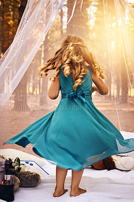 Buy stock photo Shot of an unrecognizable little girl dancing underneath her tent outside in the woods