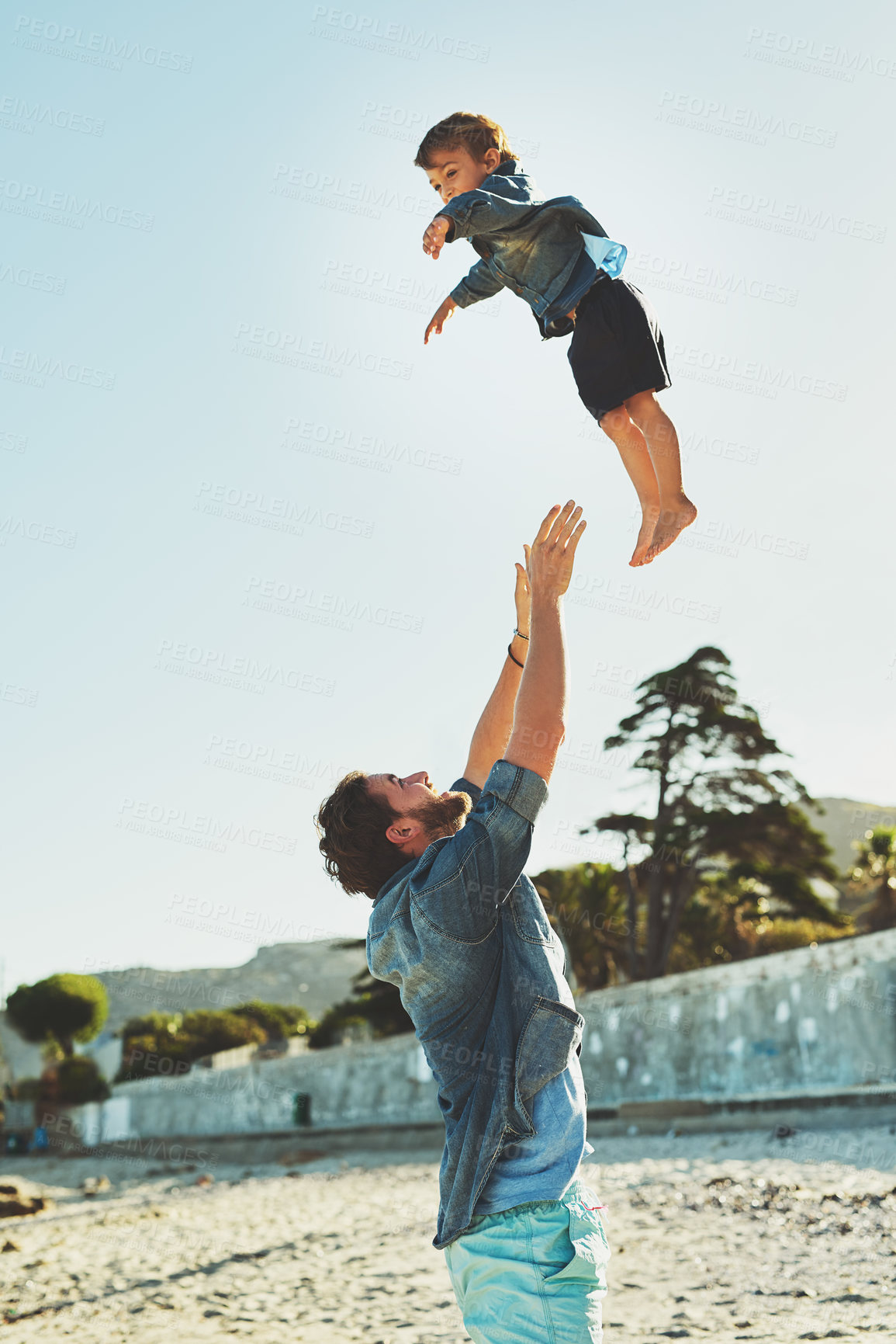 Buy stock photo Throw, dad or child at beach for playing, holiday or travel, support in Portugal with boy, toddler or family. Parent, father or kid at sea for vacation with fun adventure, wellness or nature to relax