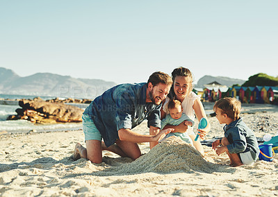 Buy stock photo Sandcastle, parents and children at the beach with bonding, love and support. Baby, mom and dad together with kids playing in the sun with happiness and smile by the ocean and sea with family
