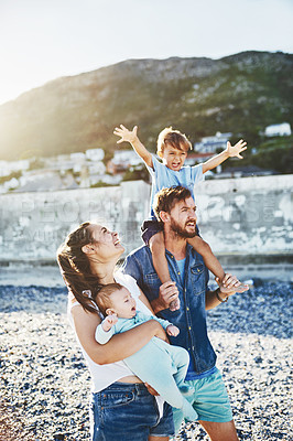 Buy stock photo Piggyback, parents or children at beach for walking, holiday or travel in Portugal with boy, baby or family. Happy, mom or father with infant at sea on vacation together for love or playing to relax