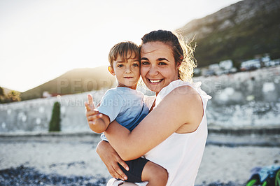 Buy stock photo Shot of a young Mother and son spending quality time at the beach