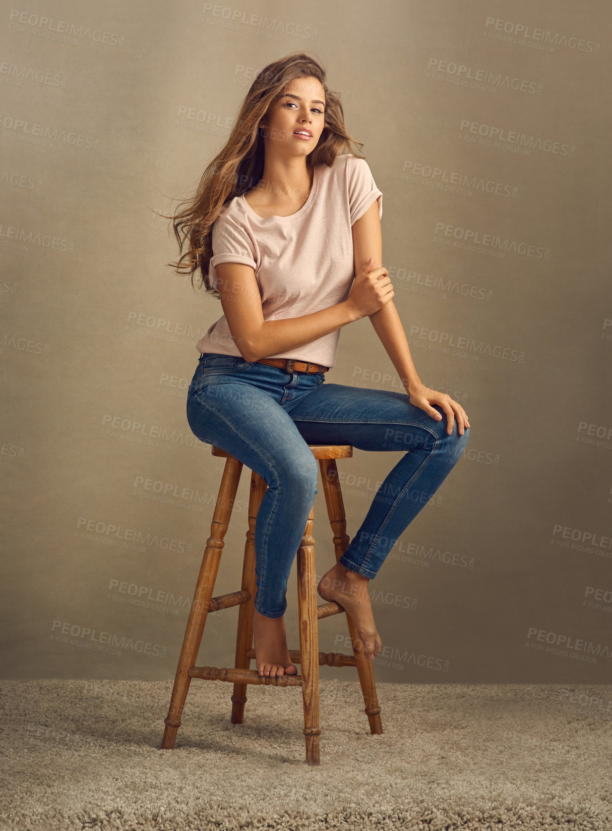 Buy stock photo Portrait, hair care or happy woman on chair for fashion in studio with confidence for style or cosmetics. Beauty, model or girl in cool clothes, denim or jeans for trendy outfit by brown background