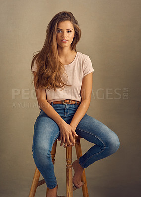 Buy stock photo Woman, fashion and hair with confidence in studio on brown background with style and swag. Female person, chair and portrait for clothes or street wear, outfit and satisfied with gen z trends