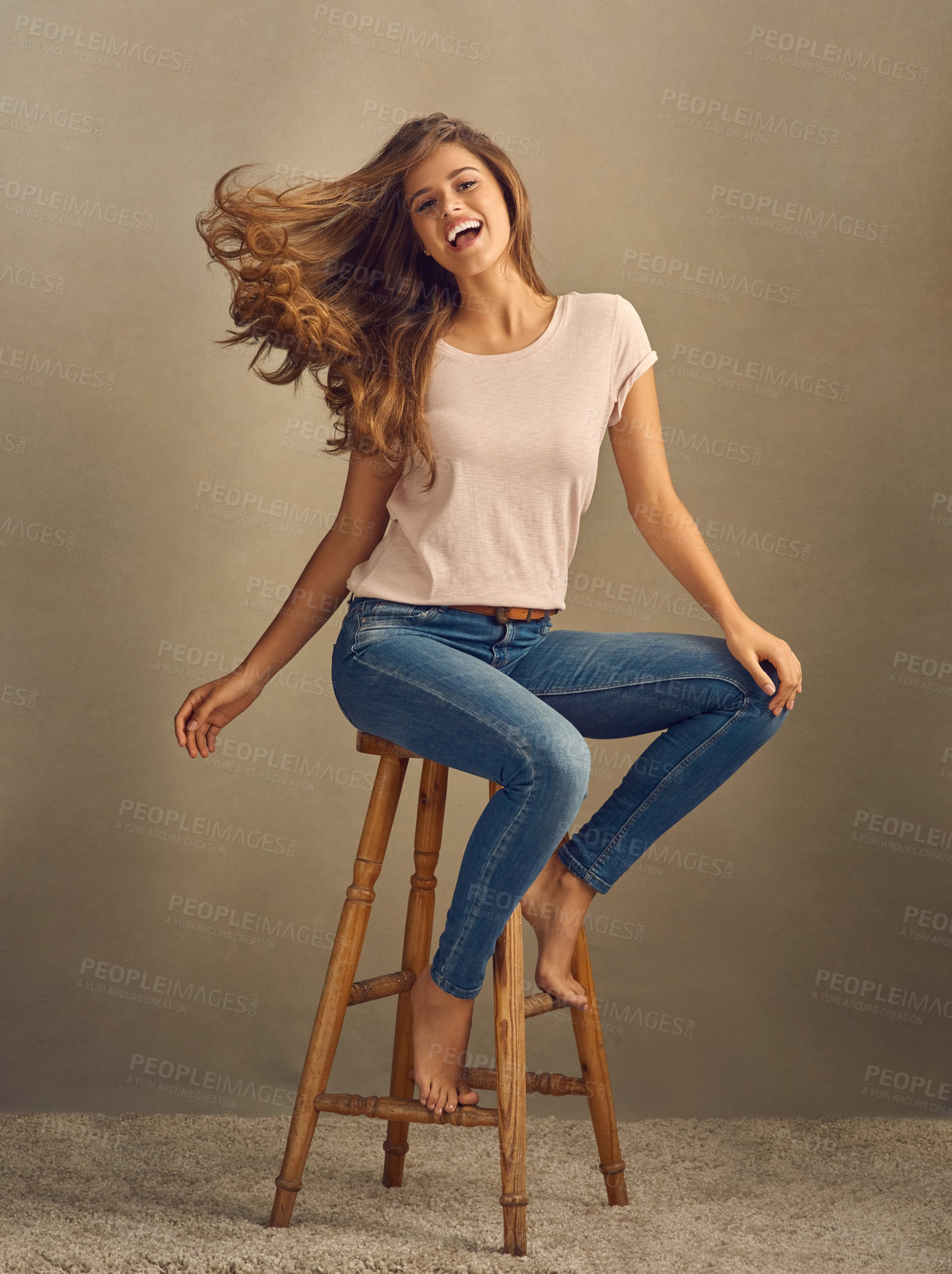 Buy stock photo Portrait, studio and woman or movement for hair on chair with confidence for style or fashion. Beauty, model girl and excited for shampoo, treatment and growth or denim for outfit by brown background