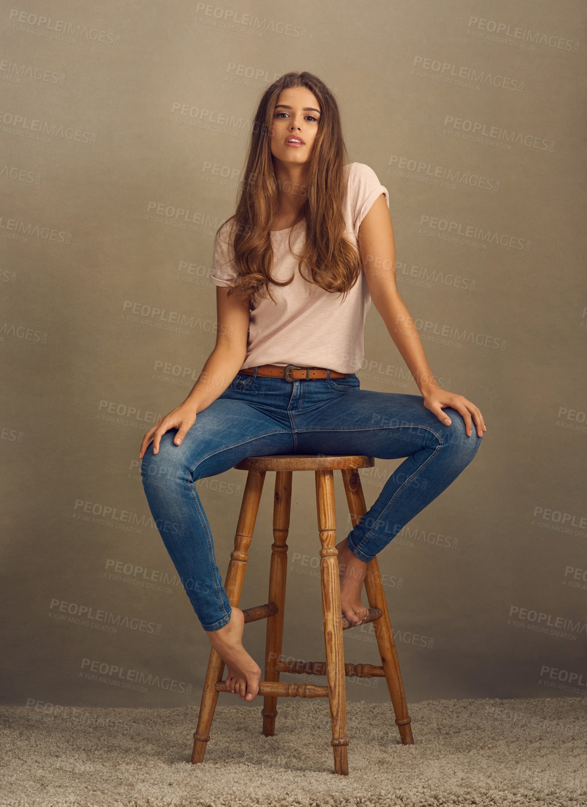 Buy stock photo Woman, fashion and chair on portrait in studio on brown background with style and swag. Female person, smile and confidence for clothes or street wear, outfit and satisfied with gen z trends