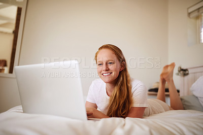 Buy stock photo Shot of a young woman laying in bed at home