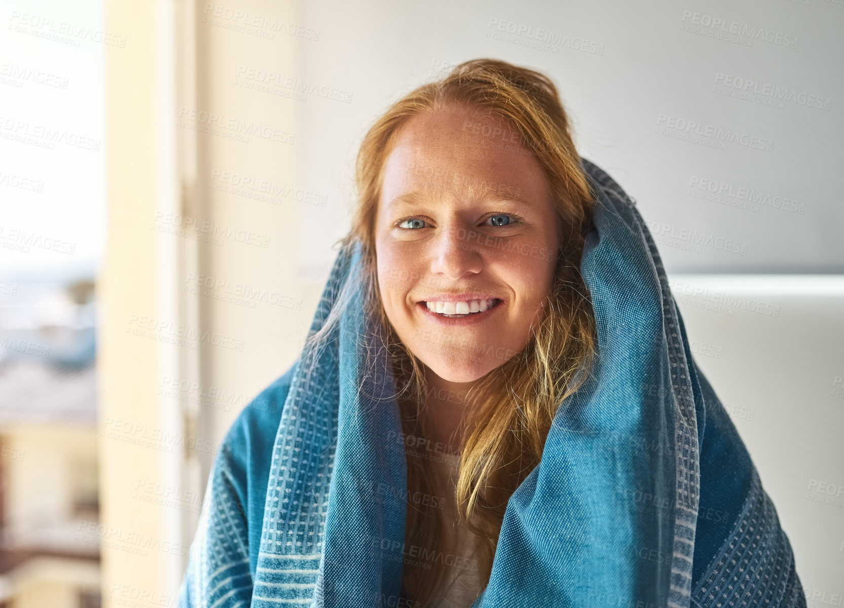 Buy stock photo Shot of a young woman covered in a blanket at home