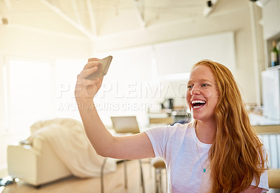 Buy stock photo Shot of a young woman taking a selfie at home