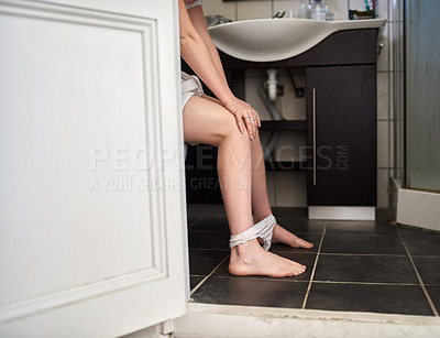 Buy stock photo Shot of an unrecognizable woman using the toilet at home