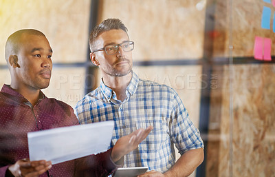 Buy stock photo Shot of men coworkers discussing ideas at work