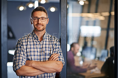 Buy stock photo Portrait of a businessman standing with his arms crossed in the office