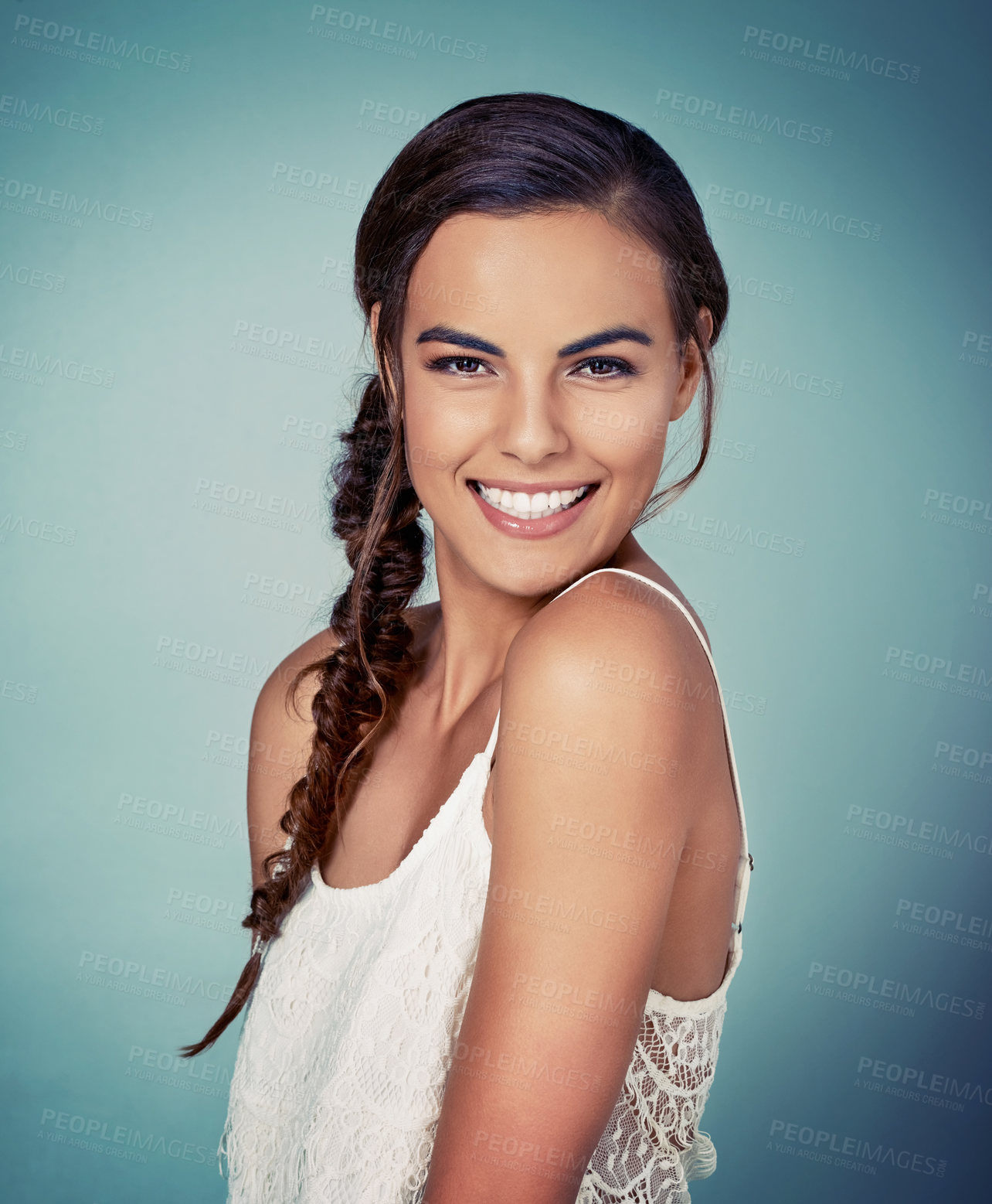 Buy stock photo Studio shot of a beautiful young woman posing against a green background