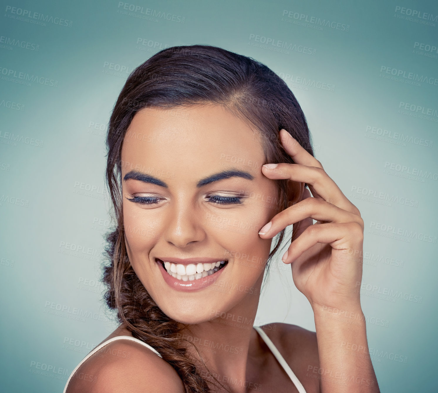 Buy stock photo Happy, confidence and girl with smile or skincare on blue background for beauty, wellness or makeup glow. Face, proud model and woman in studio for dermatology or smooth results and facial health