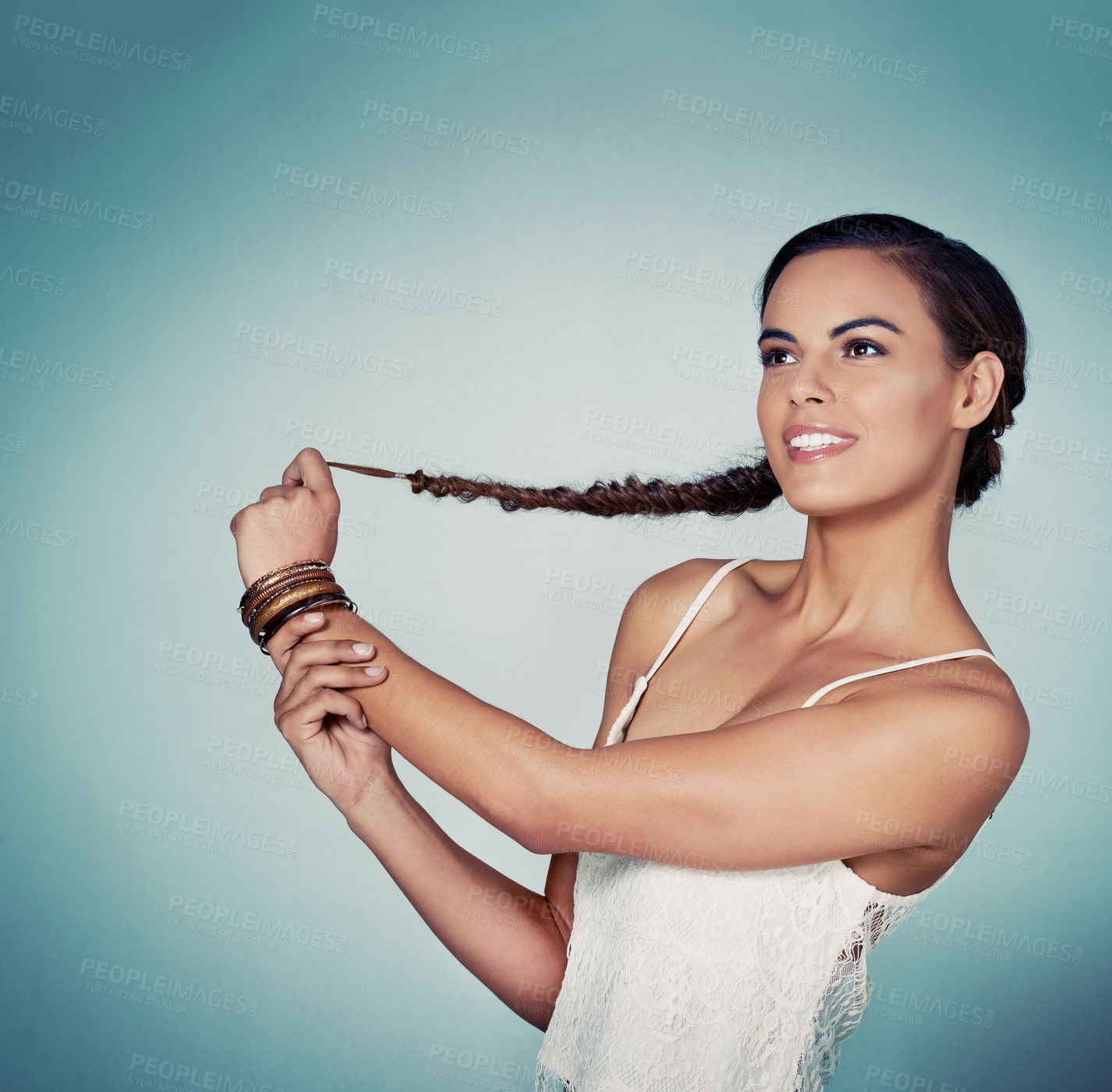 Buy stock photo Smile, studio and woman with hair, braid and person in mockup, haircare and showing of hairdo. Blue background, texture and confident in salon, shine and healthy hairstyle of model and cosmetics