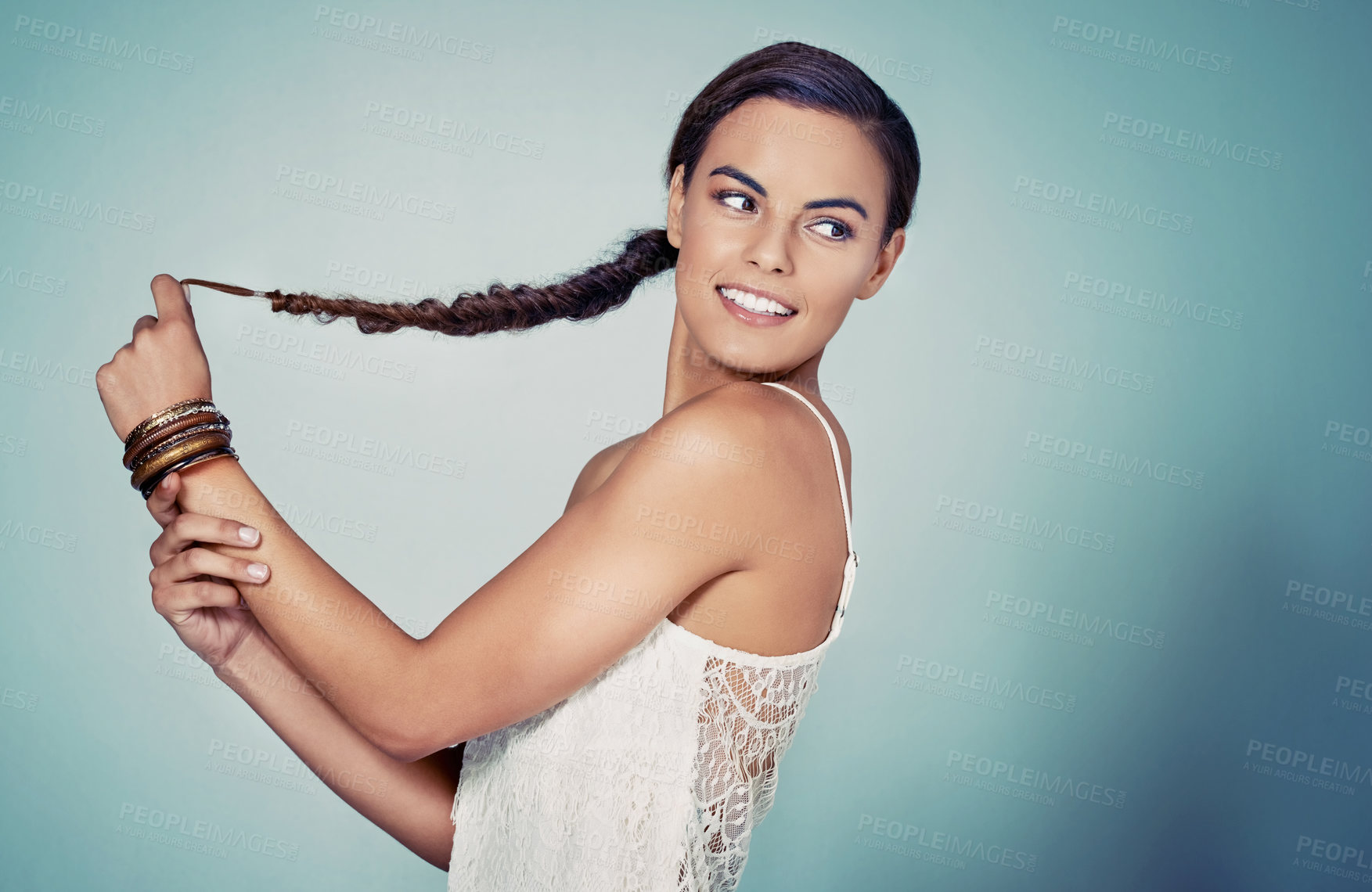 Buy stock photo Happy, studio and woman with hair, braid and person in mockup, haircare and showing of hairdo. Blue background, texture and confident in salon, shine and healthy hairstyle of model and cosmetics