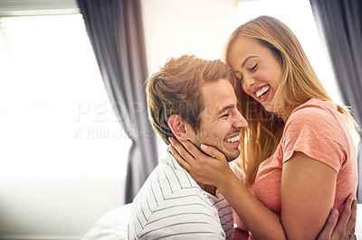 Buy stock photo Shot of a happy young couple sharing an affectionate moment in bed