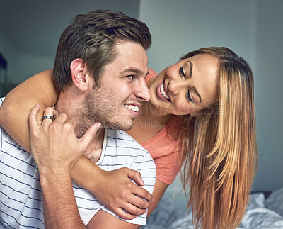 Buy stock photo Shot of a happy young couple sharing an affectionate moment in the bedroom at home
