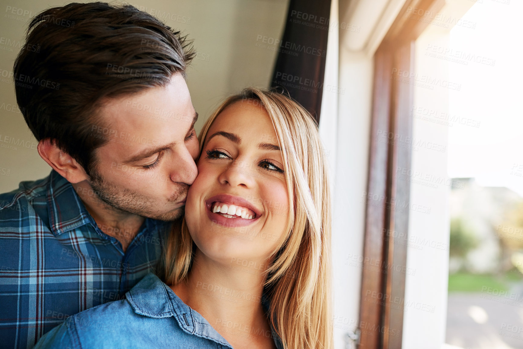 Buy stock photo Home, love and couple with affection, kiss and bonding  of people, relationship and romance in morning. House, man and woman in weekend, hug and fun in marriage, together and happy with embrace