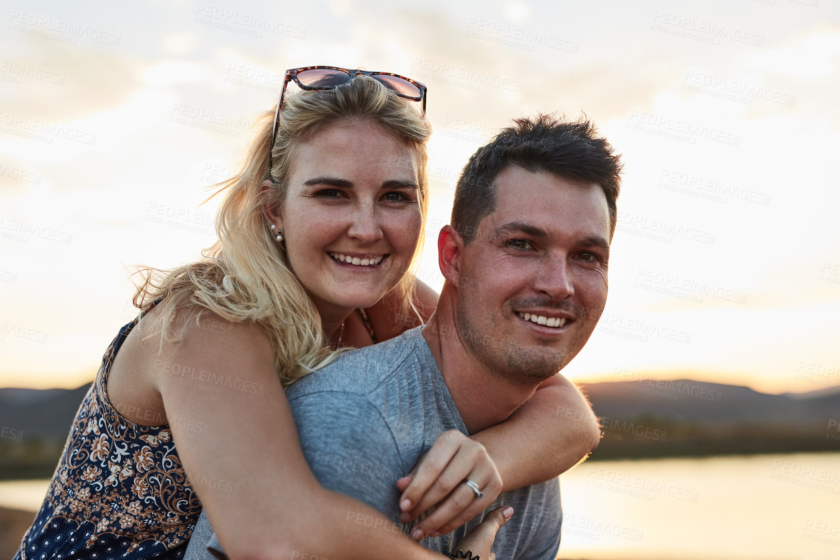 Buy stock photo Couple, piggyback and portrait in nature for vacation, relax and travel with love or leisure in Miami. People, bonding and sunset outdoor for holiday, relationship and adventure with smile by lake