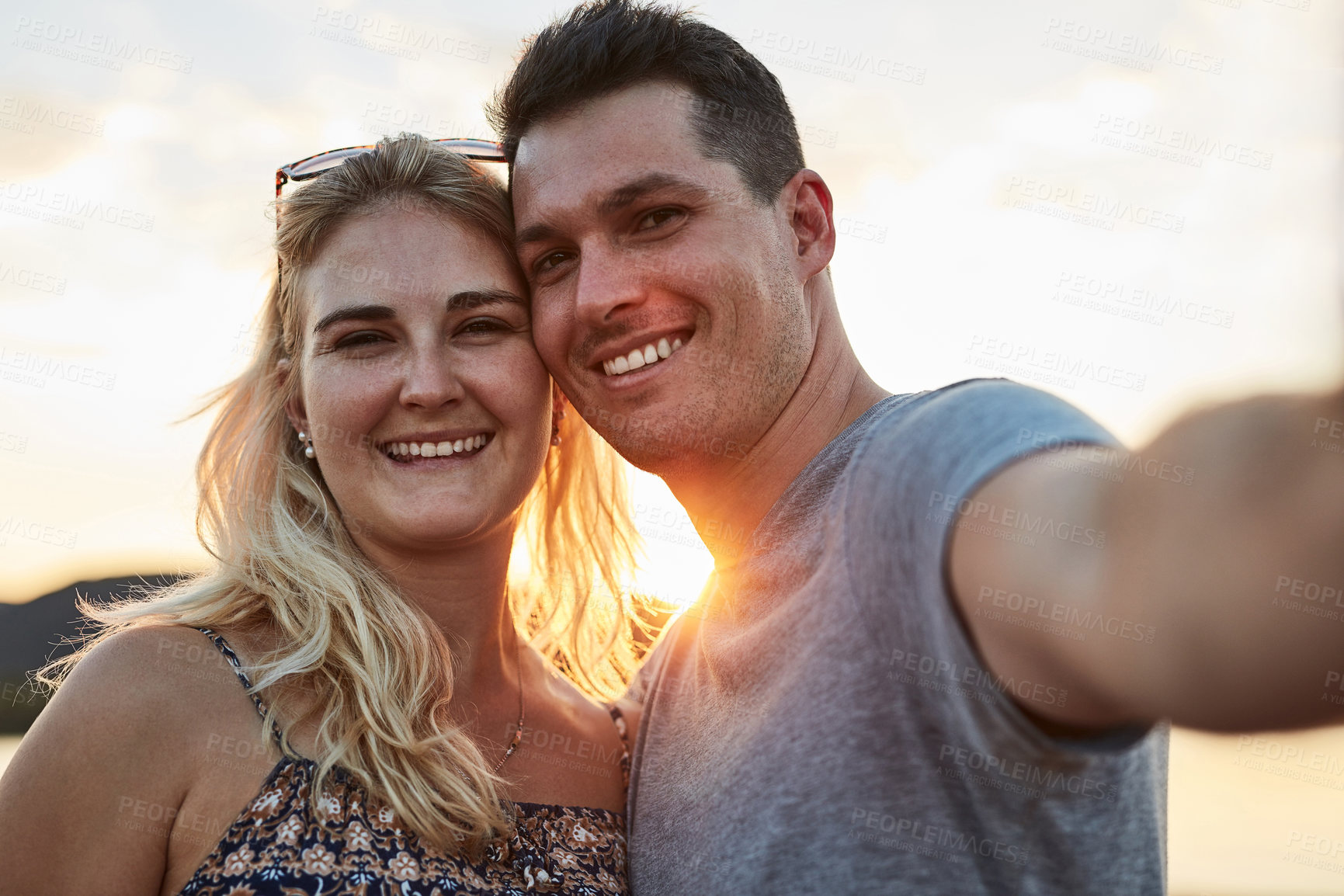 Buy stock photo Couple, selfie and sunset in nature for vacation, relax and travel with love, memory and leisure in California. People, portrait and happy for holiday, relationship and adventure with smile by lake