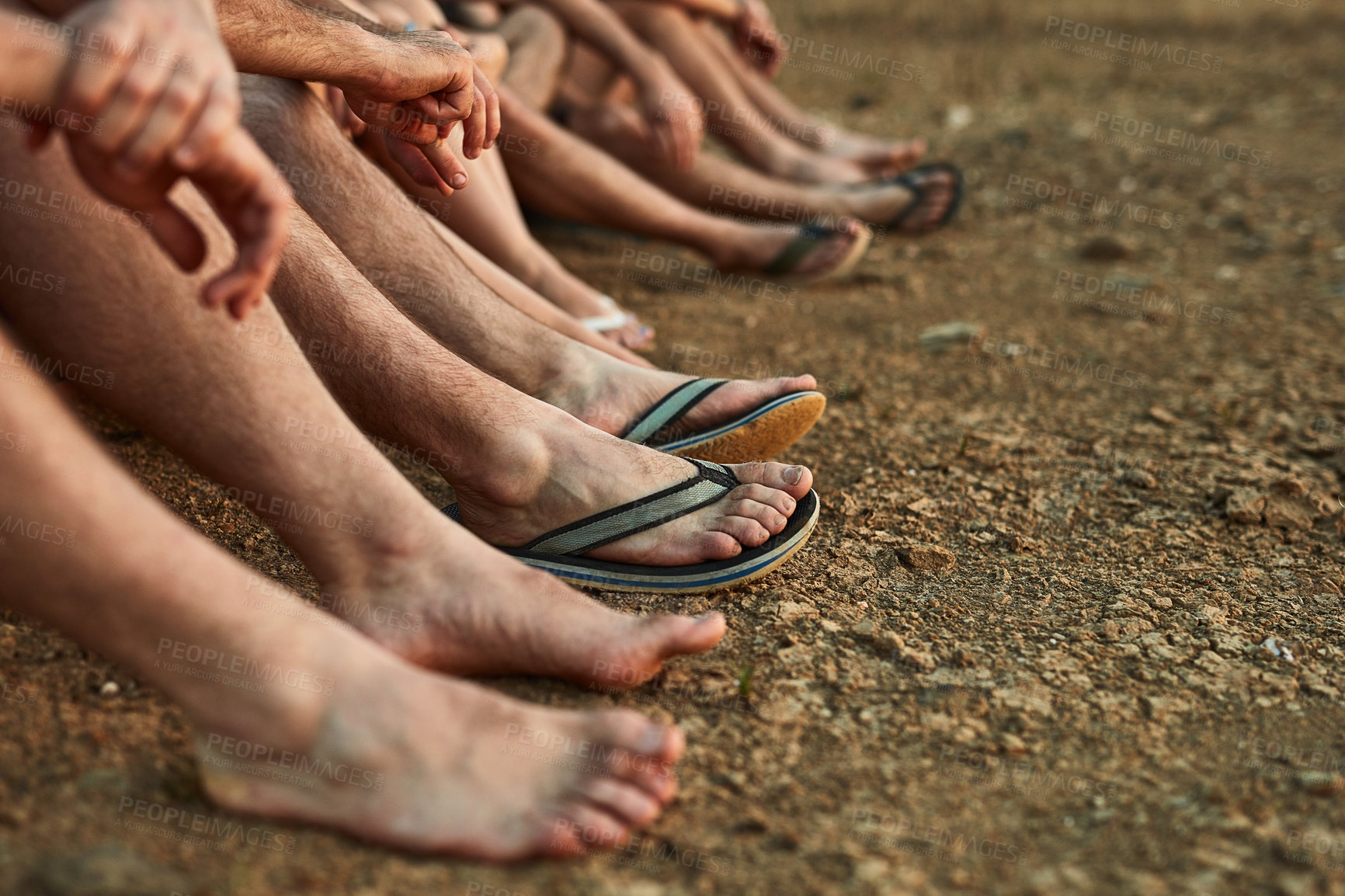 Buy stock photo Holiday, friends and feet on ground to relax with peace, support and flip flops in outdoor nature. Chill, barefoot or people sitting on sand for bonding or relationship development on vacation break