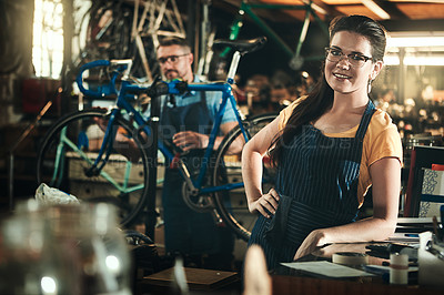 Buy stock photo Portrait, working and smile of woman in bicycle shop, repair store or cycling workshop. Face, bike mechanic and confident person, professional or technician standing with glasses in small business.
