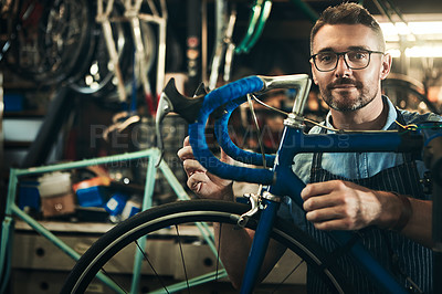 Buy stock photo Portrait, serious and repair man in bicycle shop working in store and cycling workshop. Face, bike mechanic and confident male person, professional and mature technician from Canada with glasses.