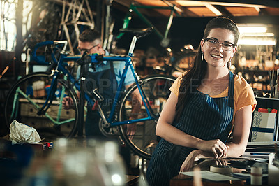 Buy stock photo Portrait, mechanic and smile of woman in bicycle shop, repair store or cycling workshop. Face, bike technician and confident female person, business owner and professional standing with glasses.