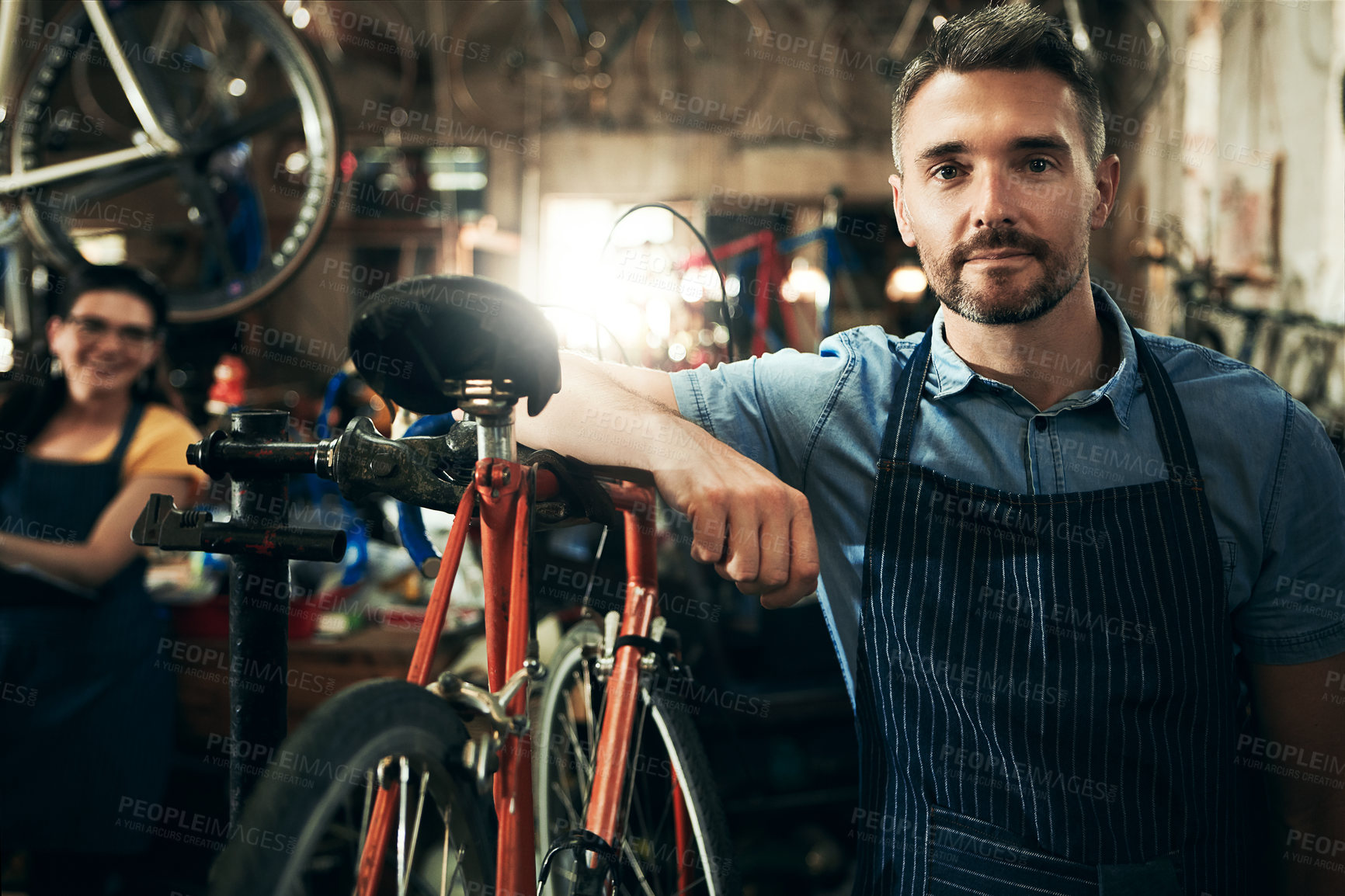 Buy stock photo Serious, portrait and technician man in bicycle shop working in store or cycling workshop for repair. Face, bike mechanic and confident male person, business owner or mature professional with pride