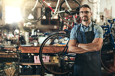 Buy stock photo Portrait, serious and repair man in bicycle shop with arms crossed in workshop. Face, bike mechanic and confident male person, professional or mature technician and glasses in store or small business