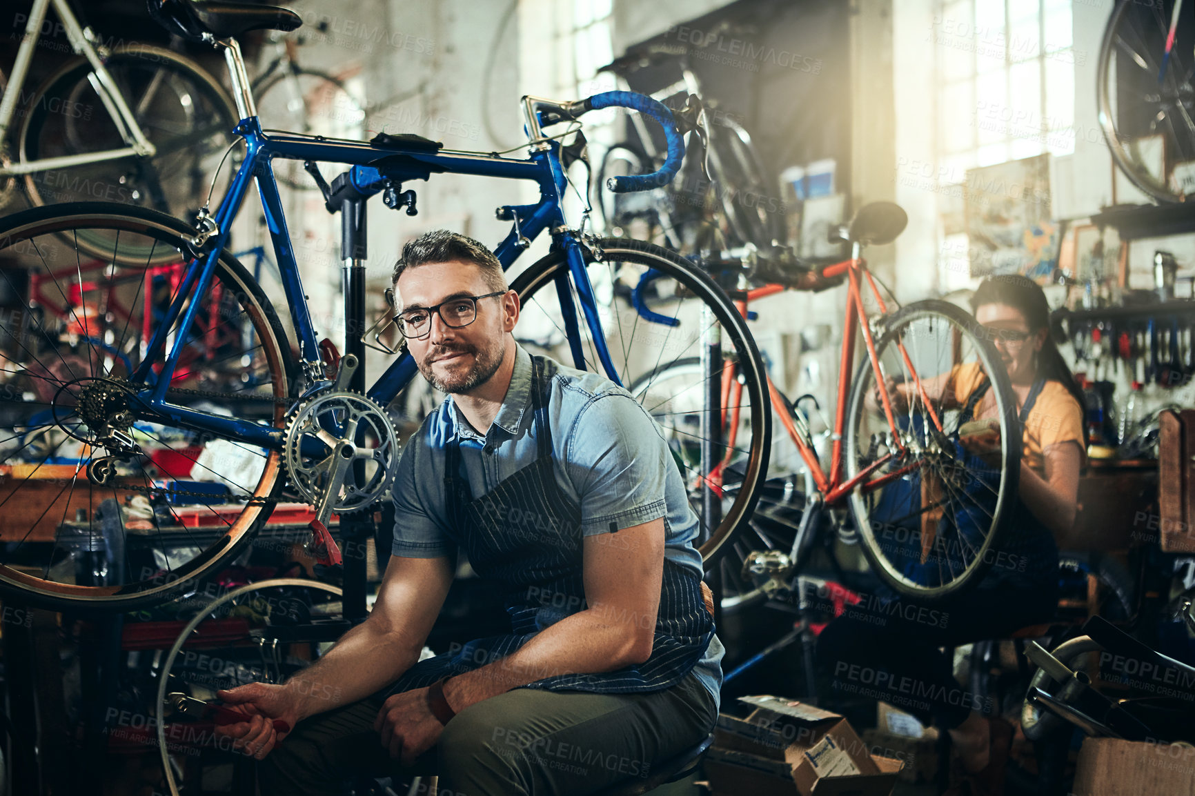 Buy stock photo Mechanic, portrait and working at startup bicycle repair shop or maintenance garage. Bike, mature man and service with a professional handyman for vehicle technician, small business and workshop