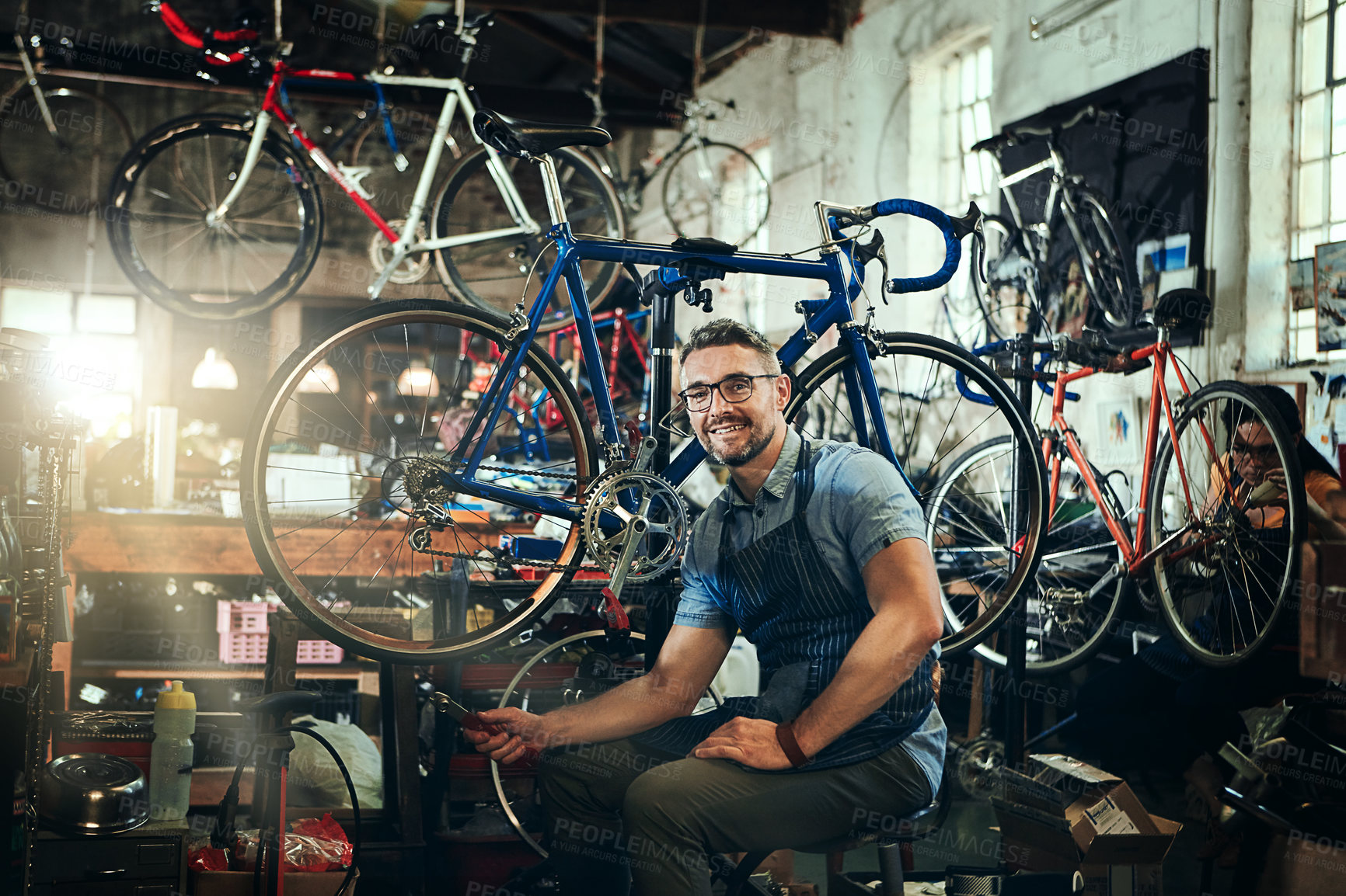 Buy stock photo Portrait, wrench and smile of repair man in bicycle shop, store or cycling workshop. Face, bike mechanic and male person, happy business owner or mature technician with glasses and confidence.
