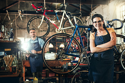 Buy stock photo Woman, portrait and arms crossed at work in bicycle repair shop or maintenance garage. Bike, mechanic and service with professional repairman coworker for startup, small business and fixing workshop