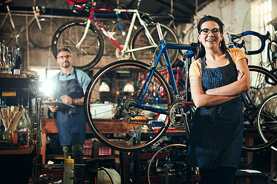 Buy stock photo Woman, portrait with arms crossed at bicycle repair shop for work in maintenance garage and smile. Bike, mechanic and service with professional coworker for startup, small business and workshop