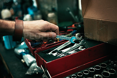 Buy stock photo Cropped shot of man’s hand reaching for a tool from his toolbox