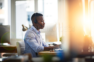 Buy stock photo Virtual assistant, consultant or black man typing in call center consulting online at customer services help desk. Contact us, email or African agent in telemarketing or telecom company in CRM office