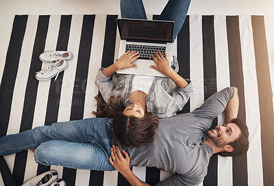 Buy stock photo Relax, laptop and couple on carpet in home with smile, bonding and streaming movie from above. Computer, man and woman on floor with online search, connection or calm weekend morning on living room