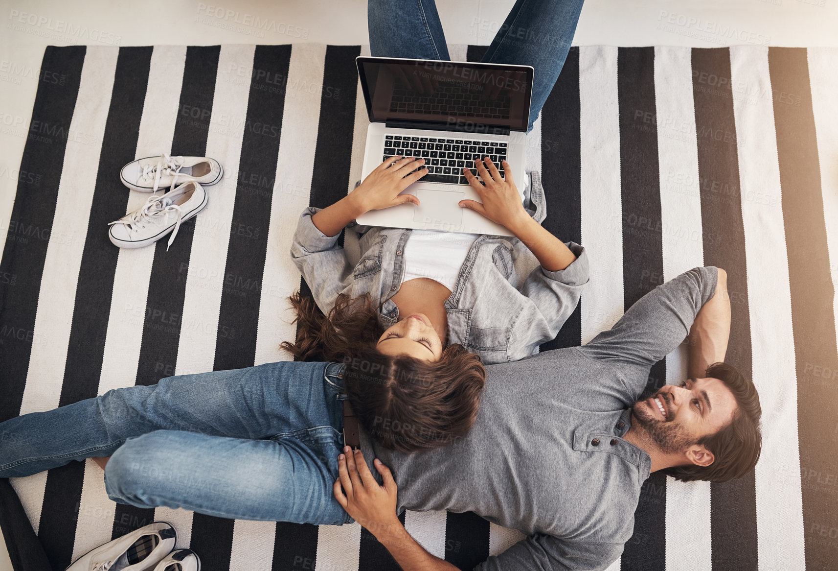 Buy stock photo Relax, laptop and couple on carpet in home with smile, bonding and streaming movie from above. Computer, man and woman on floor with online search, connection or calm weekend morning on living room