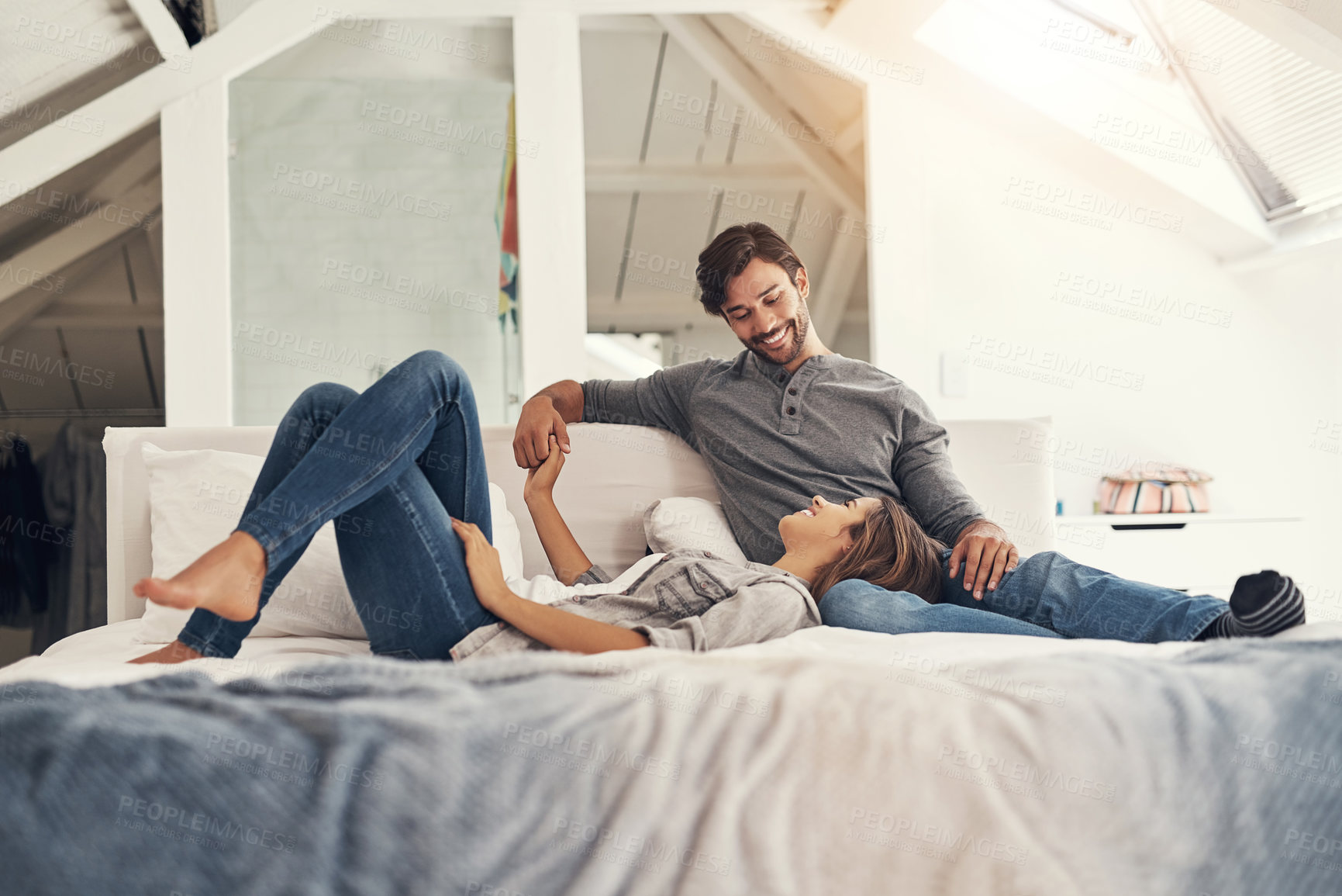 Buy stock photo Relax, couple and holding hands in bedroom in the morning with love, bonding and care together in a home with a smile. Chat, marriage and romance of happy people in a bed with support and commitment