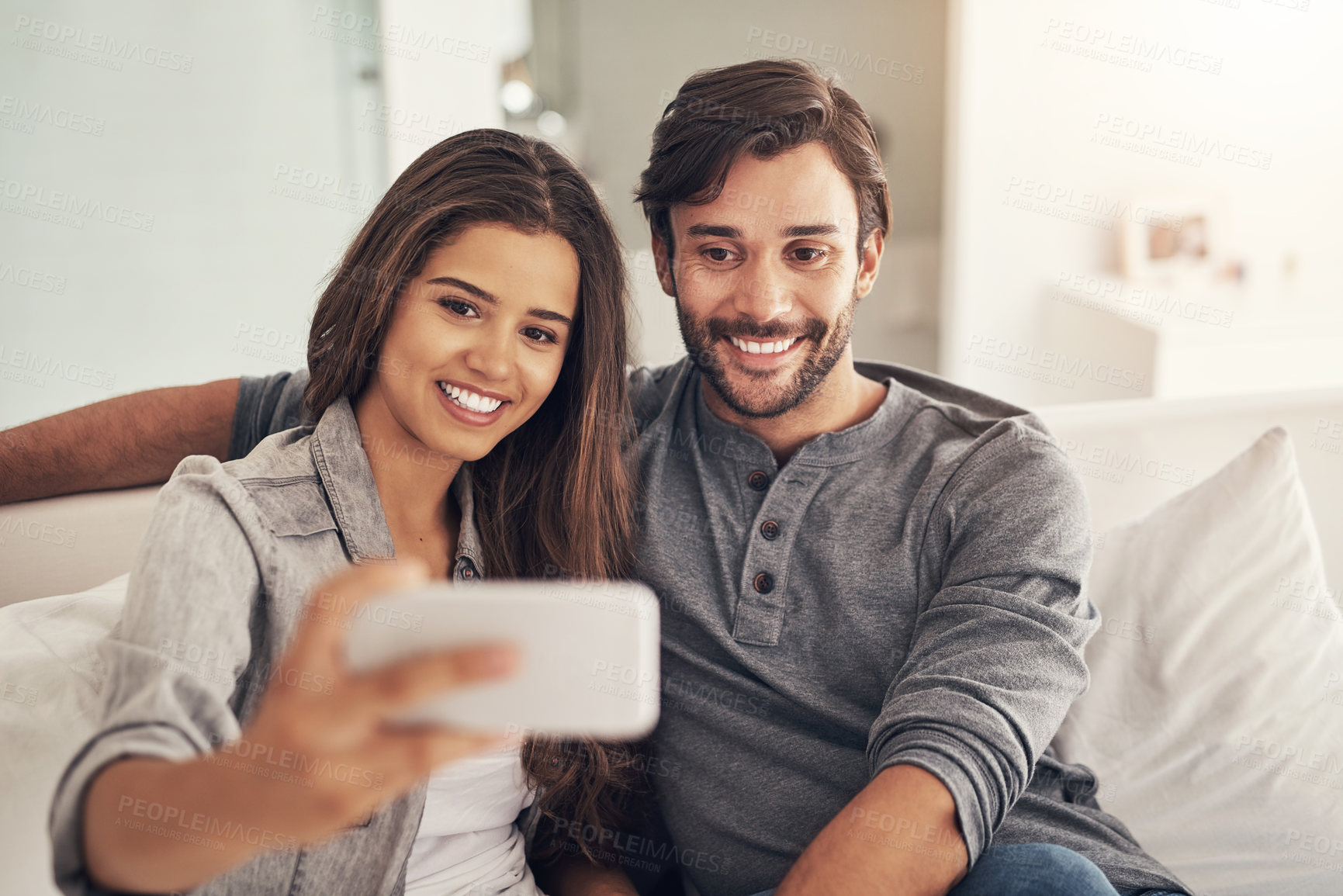 Buy stock photo Selfie, happy and couple on sofa in home for social media, online post and profile picture in living room. Dating, love and people hug, embrace and take photo for bonding, relationship and relax