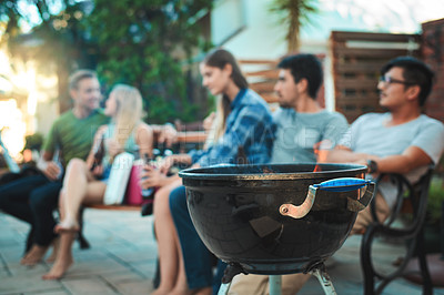 Buy stock photo Shot of a group of friends relaxing outside 