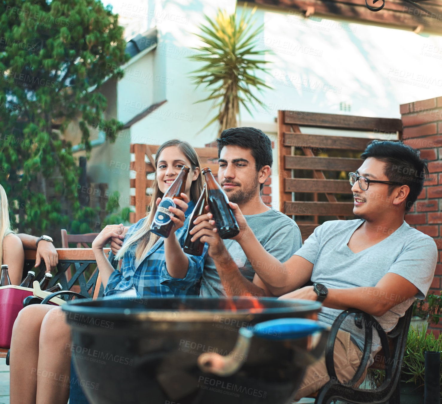 Buy stock photo Friends, beer and outdoor barbecue or party with cheers for celebration of holiday and social hangout at backyard patio. Group of people with drinks or alcohol bottle for toast and summer bbq at home