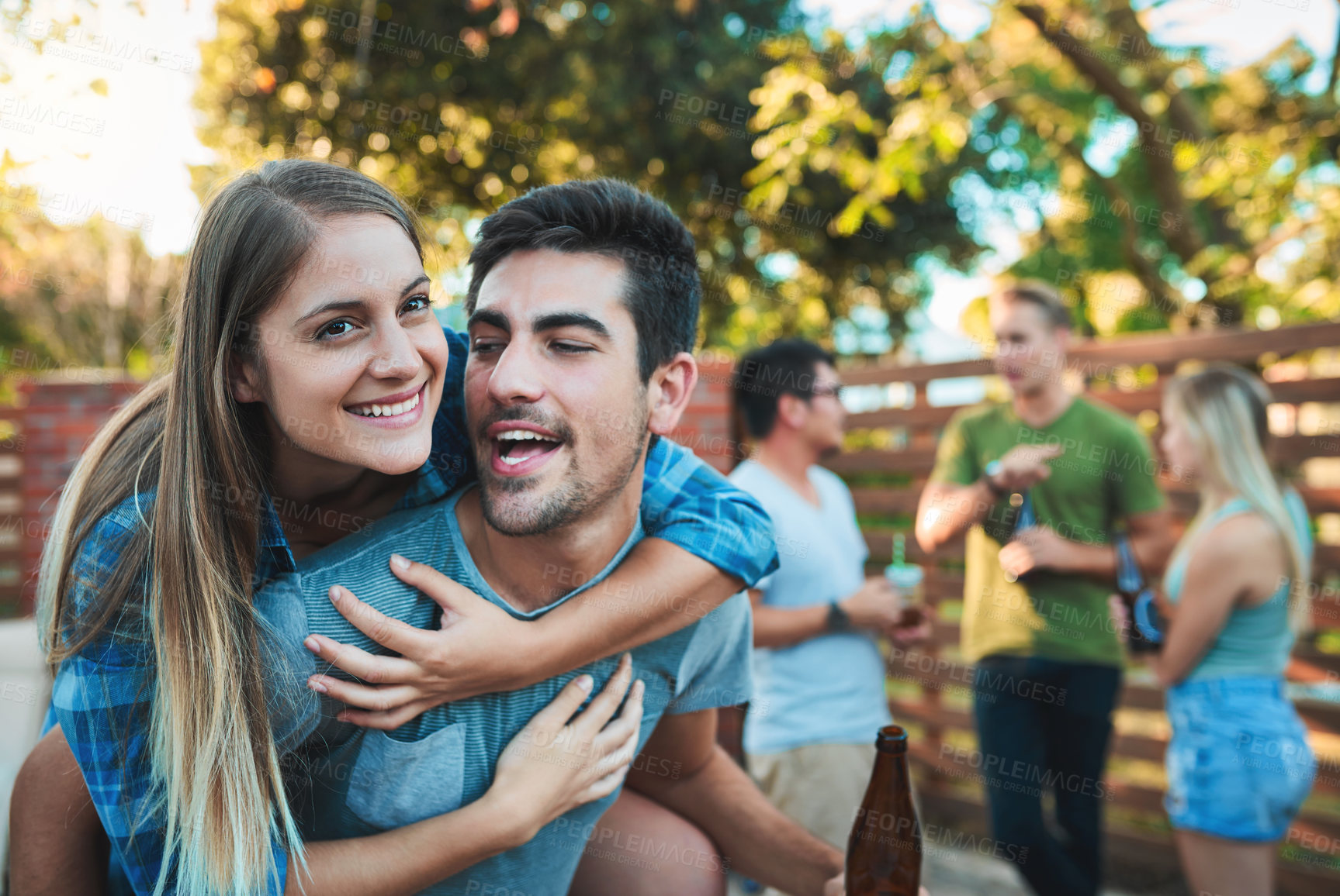 Buy stock photo Couple, hug and backyard party with talk, friends and outdoor at labor day and social event. Beer, conversation and happy people with summer fun, vacation and group reunion with smile and care