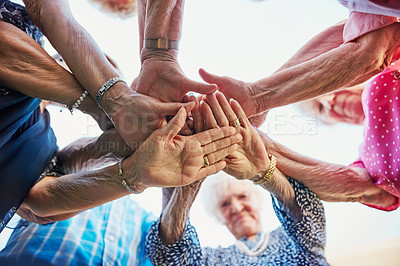 Buy stock photo Low angle shot of seniors hands huddled together outside