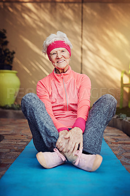 Buy stock photo Shot of a senior woman exercising at home