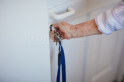 Buy stock photo Cropped shot of an elderly woman putting keys into the door at home