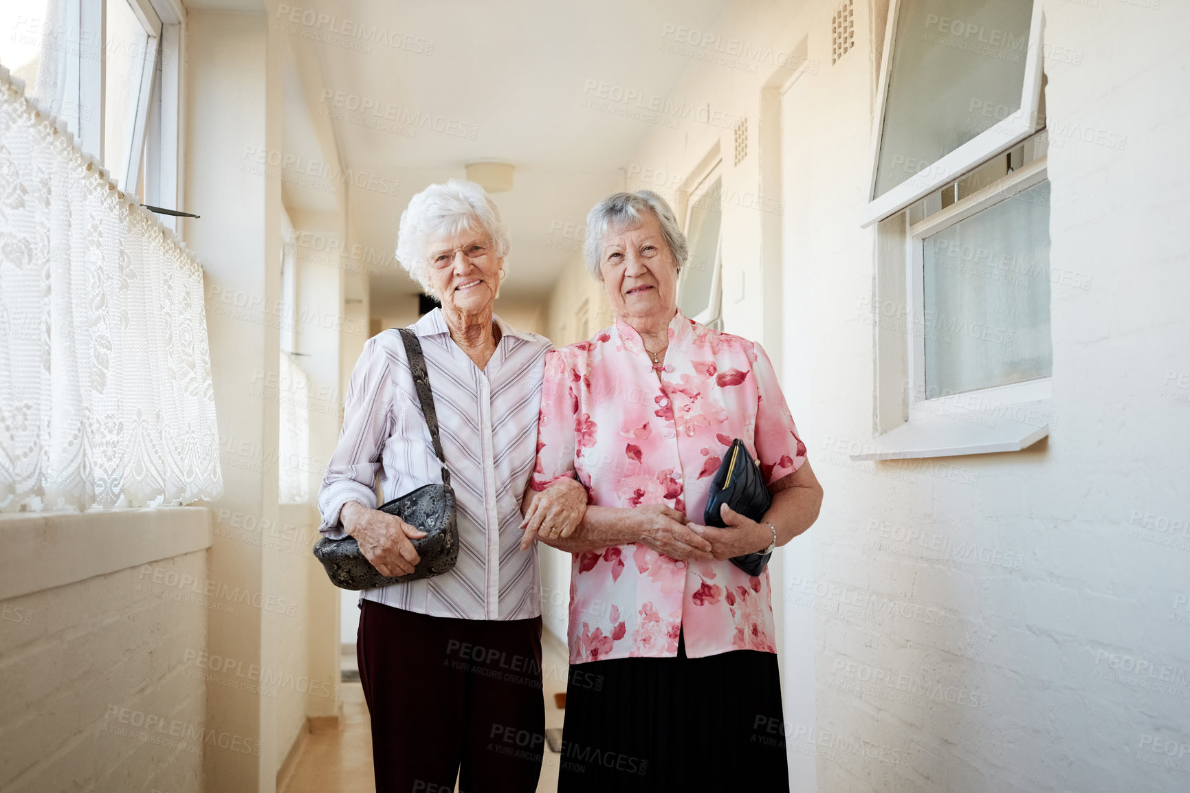 Buy stock photo Portrait of two happy elderly women carrying their bags and getting ready to go out