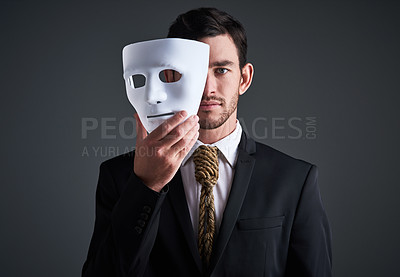 Buy stock photo Two faces, holding mask and businessman portrait in a studio with serious face with secret and fraud. Worker or corporate criminal with rope tie showing identity theft or liar in business suit mockup