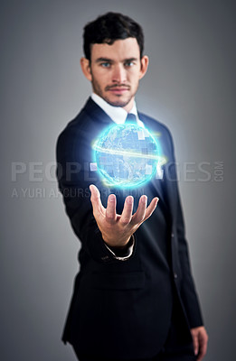 Buy stock photo Studio portrait of a young businessman holding a glowing orb against a gray background
