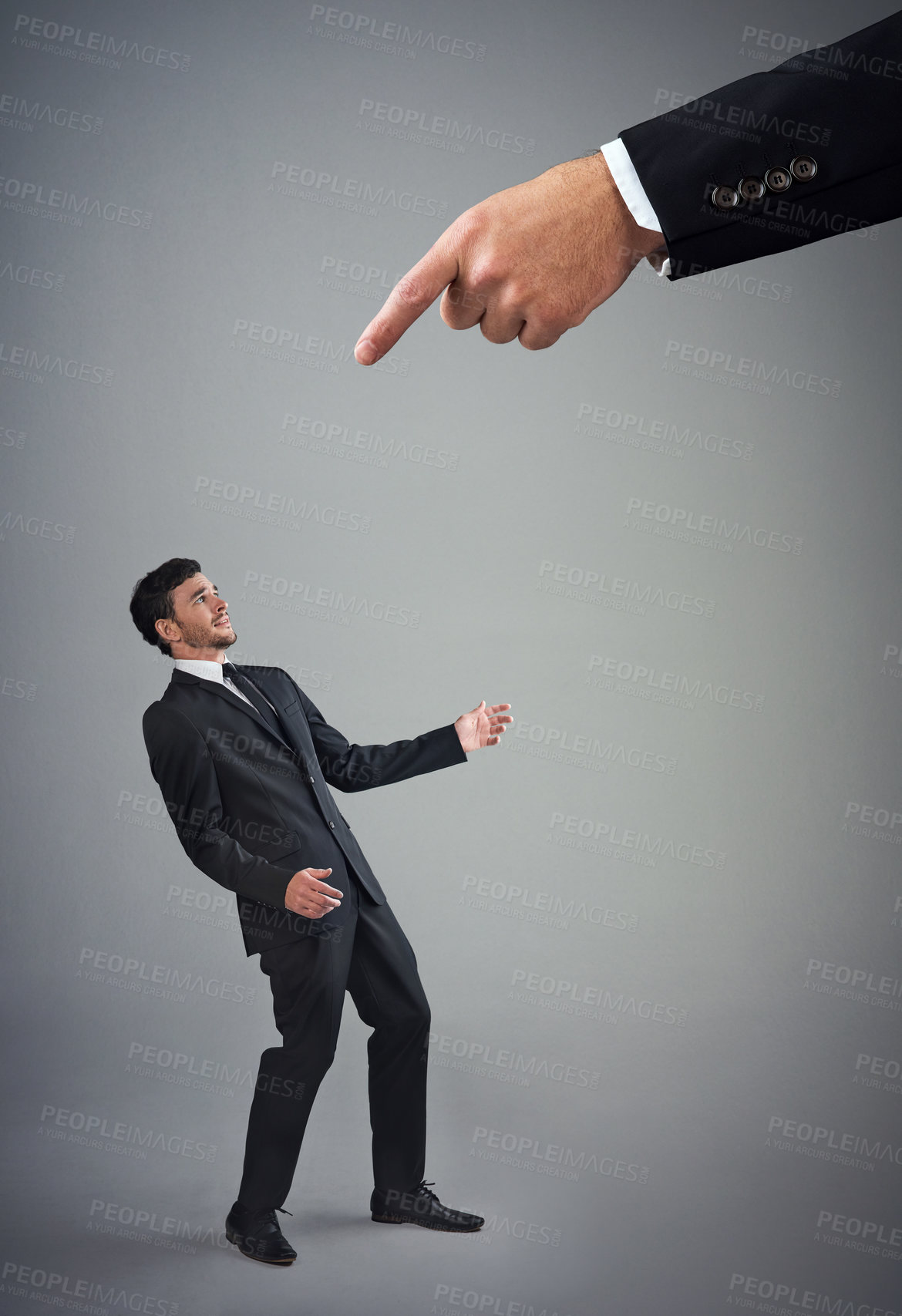 Buy stock photo Business, man or small with pointing for warning, discipline or manipulation in studio. Corporate bullying, boss hand or male employee on gray background for accountability, responsibility or mistake